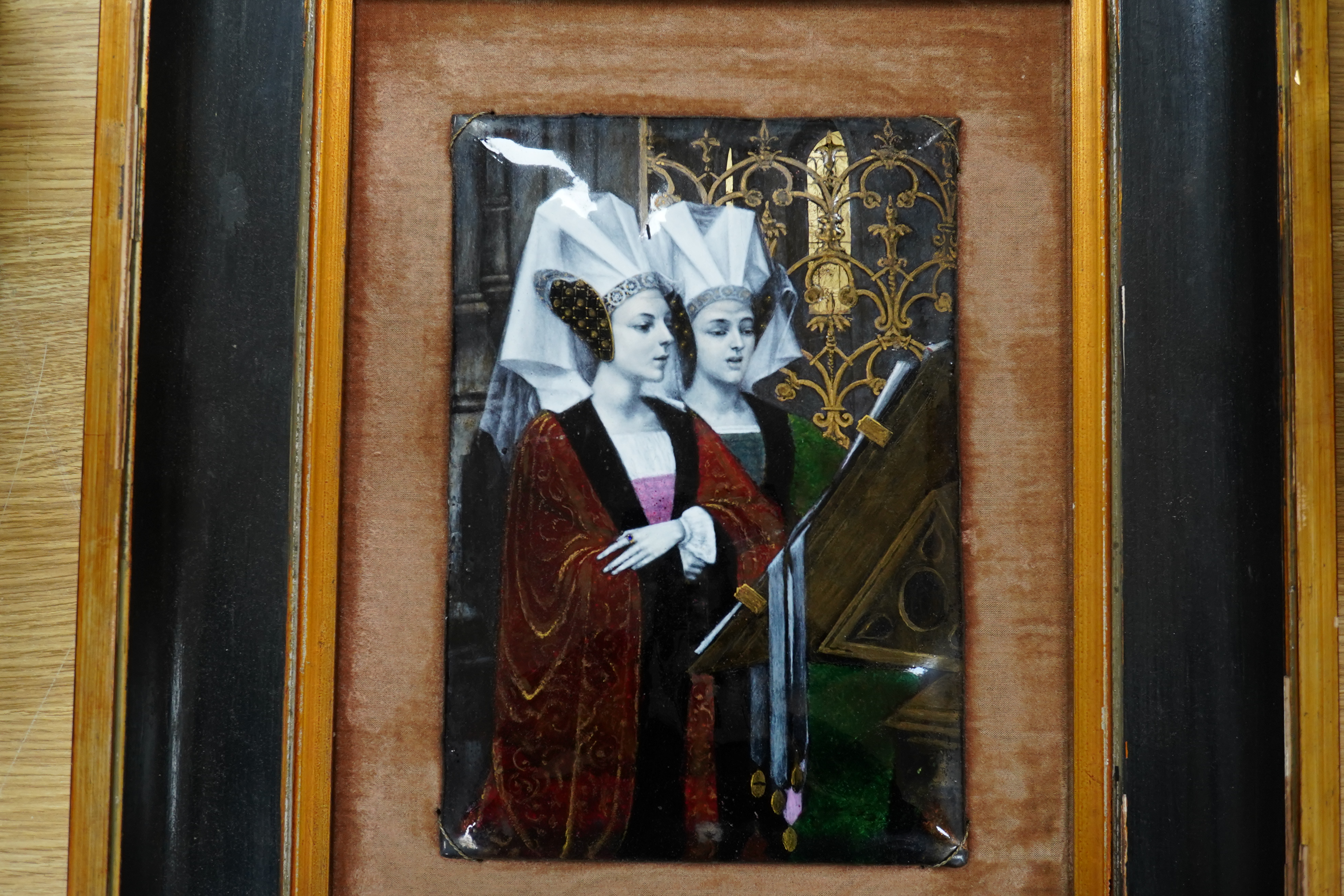 A framed French figural enamel plaque of a religious Renaissance scene of two ladies singing, plaque 19cm x 28cm. Condition - plaque in good condition, some minor damage to paint of frame